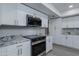 Modern kitchen with white cabinets, granite countertops and stainless steel appliances at 9614 W Greenhurst Dr, Sun City, AZ 85351