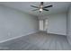 Bright bedroom with gray carpeting and ceiling fan at 9614 W Greenhurst Dr, Sun City, AZ 85351