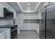 Modern kitchen with white cabinets, granite countertops, and stainless steel appliances at 9614 W Greenhurst Dr, Sun City, AZ 85351