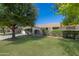 House exterior showcasing a large front yard and mature landscaping at 9614 W Greenhurst Dr, Sun City, AZ 85351