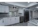 Modern kitchen with white cabinets, granite countertops and stainless steel appliances at 9614 W Greenhurst Dr, Sun City, AZ 85351