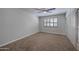 Bright bedroom featuring plantation shutters and built-in storage at 9614 W Greenhurst Dr, Sun City, AZ 85351