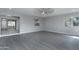 Open living room with kitchen pass-through and gray vinyl flooring at 9614 W Greenhurst Dr, Sun City, AZ 85351