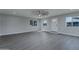Living room with gray vinyl flooring, ceiling fan and front door view at 9614 W Greenhurst Dr, Sun City, AZ 85351