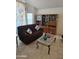 Living room with sofa, coffee table, and built-in shelving at 16549 N 91St Dr, Peoria, AZ 85382