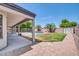 Relaxing backyard oasis featuring a sparkling pool, grassy area, and covered patio at 654 S Sabrina --, Mesa, AZ 85208