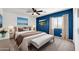 Serene bedroom with navy blue accent wall and cozy bedding at 654 S Sabrina --, Mesa, AZ 85208