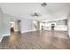 Open-concept living area with wood-look floors and views into the kitchen at 654 S Sabrina --, Mesa, AZ 85208