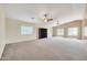 Large bedroom with neutral carpeting, two windows, and ceiling fan at 654 S Sabrina --, Mesa, AZ 85208