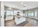 Spacious kitchen with granite island, white cabinets, and wood-look flooring at 654 S Sabrina --, Mesa, AZ 85208