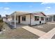 Single-wide manufactured home with covered carport and landscaped yard at 3330 E Main St # 440, Mesa, AZ 85213