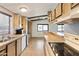 View of kitchen with wood cabinets, tiled floors, and a stove at 3330 E Main St # 440, Mesa, AZ 85213