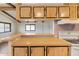 Kitchen features wood cabinets, a built-in range, and a breakfast bar at 3330 E Main St # 440, Mesa, AZ 85213