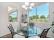 Breakfast nook with glass-top table, four chairs, and large windows at 20285 N Winter Escape Ct, Maricopa, AZ 85138