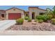 Single-story house with red garage door and landscaped yard at 20285 N Winter Escape Ct, Maricopa, AZ 85138