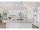 Bright kitchen with white cabinets, granite island, and stainless steel appliances at 20285 N Winter Escape Ct, Maricopa, AZ 85138