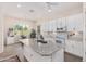 Open kitchen features a large island, white cabinets, and breakfast nook at 20285 N Winter Escape Ct, Maricopa, AZ 85138