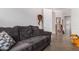 Cozy living room with gray sofa and hardwood floors at 20285 N Winter Escape Ct, Maricopa, AZ 85138