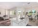 Spacious kitchen with an island, white cabinets, and views to the living room at 20285 N Winter Escape Ct, Maricopa, AZ 85138