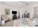 Comfortable bedroom with a dresser and TV at 20285 N Winter Escape Ct, Maricopa, AZ 85138