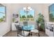 Bright breakfast nook with glass table and modern chandelier at 20285 N Winter Escape Ct, Maricopa, AZ 85138