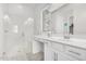 Modern bathroom with double sinks and a walk-in shower at 20285 N Winter Escape Ct, Maricopa, AZ 85138