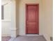 Red front door entrance with neutral colored stucco walls at 20285 N Winter Escape Ct, Maricopa, AZ 85138