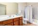 Clean bathroom with wood vanity and colorful shower curtain at 1560 E Melrose Dr, Casa Grande, AZ 85122