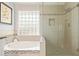 Relaxing bathroom with soaking tub, glass shower, and mosaic tile accents at 4536 E Via Dona Rd, Cave Creek, AZ 85331