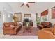 Spacious living room with leather sofas and a large TV at 4536 E Via Dona Rd, Cave Creek, AZ 85331