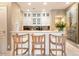 Small kitchen with white cabinets, granite countertops, and bar seating at 40 Biltmore Est, Phoenix, AZ 85016