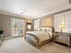 Main bedroom with a large bed, French doors, and a mirrored dresser at 40 Biltmore Est, Phoenix, AZ 85016