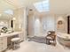 Spa-like bathroom with skylight, walk-in shower, and soaking tub at 40 Biltmore Est, Phoenix, AZ 85016