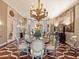 Formal dining room with a large table, ornate chandelier, and hardwood floors at 40 Biltmore Est, Phoenix, AZ 85016