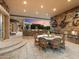 Outdoor dining area with stone walls, a built-in grill, and a seating area at 40 Biltmore Est, Phoenix, AZ 85016