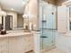 Bathroom with a glass shower, white tile, and a beige vanity at 40 Biltmore Est, Phoenix, AZ 85016