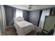 Cozy bedroom with a double bed and gray wall accents at 5753 N 31St Ln, Phoenix, AZ 85017