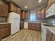 Kitchen with wood cabinets and white appliances at 650 N Hawes Rd # 3404, Mesa, AZ 85207