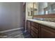 Double vanity bathroom with wood cabinets and tiled flooring at 650 N Hawes Rd # 3404, Mesa, AZ 85207