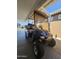 Black golf cart parked under carport at 650 N Hawes Rd # 3404, Mesa, AZ 85207