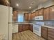 Kitchen with wood cabinets and white appliances at 650 N Hawes Rd # 3404, Mesa, AZ 85207