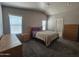 Spacious bedroom with two windows and wood furniture at 650 N Hawes Rd # 3404, Mesa, AZ 85207