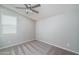 Simple bedroom with neutral walls and ceiling fan at 16172 W Alameda Rd, Surprise, AZ 85387