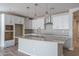 Modern kitchen with white cabinets and curved island at 16172 W Alameda Rd, Surprise, AZ 85387