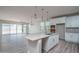 Open kitchen island with white cabinets and pendant lighting at 16172 W Alameda Rd, Surprise, AZ 85387