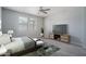 Bedroom with a bed, carpet, and modern TV stand at 16172 W Alameda Rd, Surprise, AZ 85387