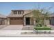 One-story home with a brown garage door and stone accents at 16172 W Alameda Rd, Surprise, AZ 85387