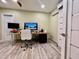 Home office with light wood-look floors, a desk, and sliding barn door at 895 W Tyson St, Chandler, AZ 85225