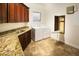 Laundry room with wood cabinets, granite counters, and washer/dryer at 19950 W Cambridge Ave, Buckeye, AZ 85396