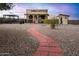 Landscaped backyard with brick pathway and mercantile building at 19950 W Cambridge Ave, Buckeye, AZ 85396